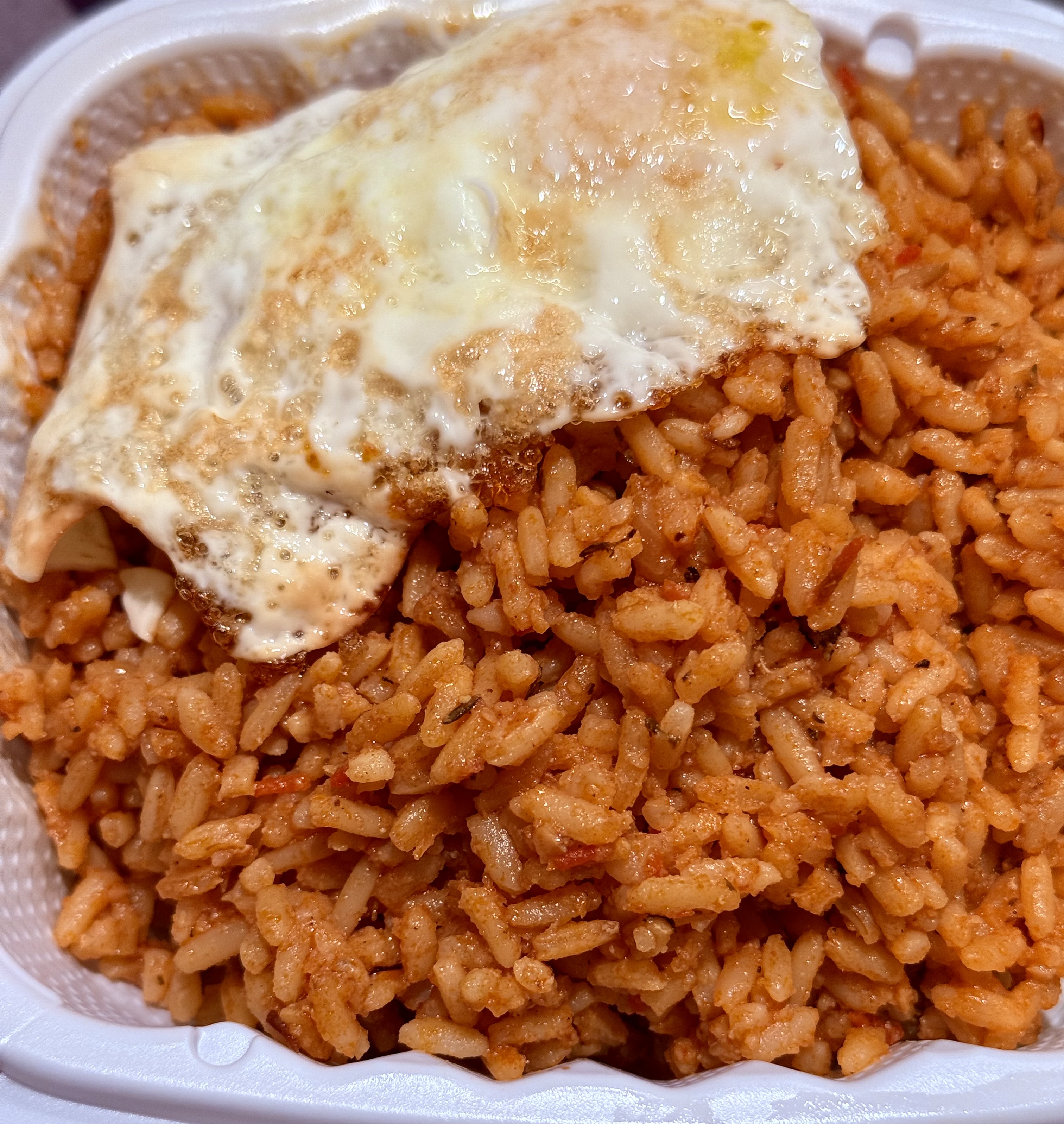 Jollof Rice topped with perfectly fried egg
